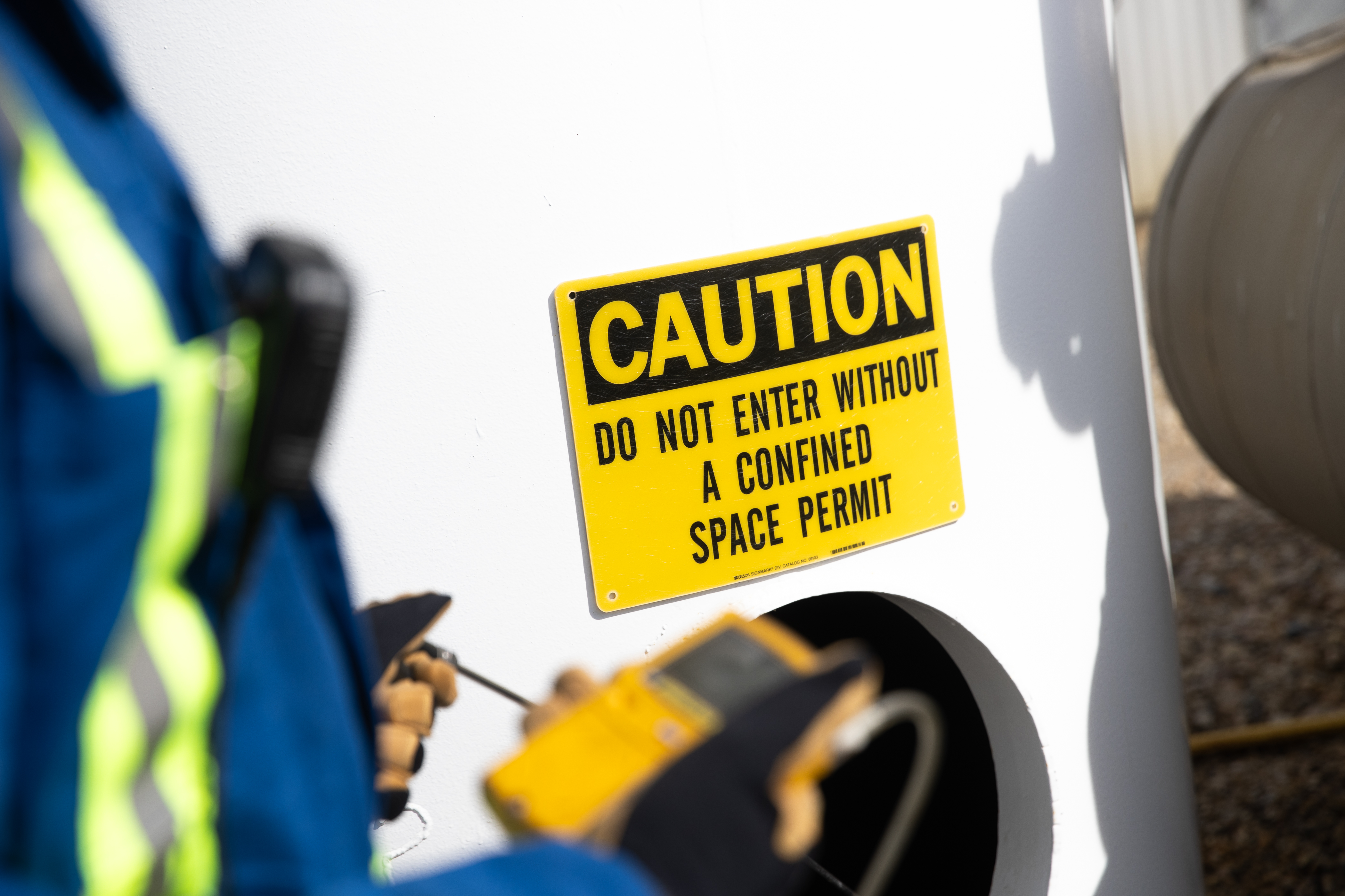 A caution sign with text: Do not enter without confined space permit